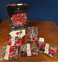 LEGO set pieces in plastic bags laid out on table with instruction manual and box behind them, bags 1 and 3 opened