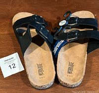 Pair of men's black sandals viewed from above showing straps and footbed with brand logo 'Mission Ridge' and size M 10/11