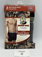 Front view of Mossy Oak men's boxer briefs 2-pack packaging showing brand, size, and promotional image of model wearing boxer briefs