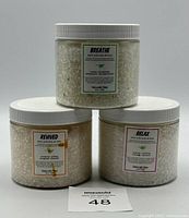 Three jars of bath salts from Naturally Vain labeled Breathe, Revived, and Relax.