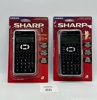 Two Sharp EL-W516XB-SL scientific calculators in unopened original red blister packaging.