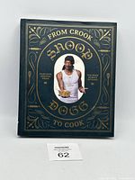 Front cover of cookbook showing Snoop Dogg and title with gold embossed details.