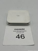 Top view of white Square SPC1-01 contactless and chip card reader showing contactless symbol on front