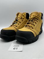 Pair of tan and black Workload Trooper protective work boots size 11, angled side view showing robust sole and toe protection.
