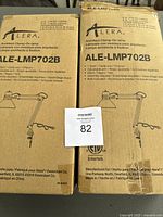 Closed cardboard boxes of two Alera Architect Clamp-On Lamps, model ALE-LMP702B