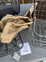 Black mesh wire basket, natural woven burlap basket, and rectangular black wire basket shown with a label 110