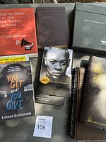 Lot showing five books related to music industry, artist biographies, record keeping, and a Bentley car specification set in a folder.