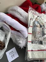 Photo showing red and white Santa hats with plush fur trim, part of the lot