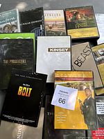 Photo showing multiple DVD movie screeners with visible titles including The Producers, Kinsey, Beast, Bolt, and others.