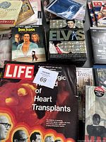 Close-up showing Elvis Presley 75th Anniversary DVD Collection, Don Juan DeMarco DVD, Life magazine, and other media items packed in a box