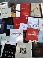 Full view of various DVD screeners in cardboard sleeves arranged together revealing multiple titles for awards consideration.