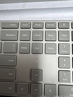 Close-up of section of keyboard showing keys including PrtScn, ScrLk, Pause, NumLK, arrow keys, Backspace, Insert, Delete, Home, End, PgUp, PgDn, Clear, and numeric keypad keys.