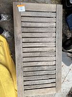 Top view of the wooden slatted outdoor table showing the full surface and weathered wood condition.