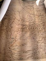 Close-up photo showing a map featuring Afghanistan, Soviet Union, and Persia with vintage style and coffee stain effect