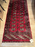 Full view of the vintage rectangular rug showing overall pattern and colors