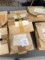 Boxes containing the 8 Bradford Exchange Knowles Wizard of Oz collector plates stacked on table, showing original packaging and mailing labels.