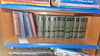 Shelf of hardback books including the Mark Twain volumes and other vintage titles.