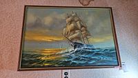 Frontal photo showing entire framed oil painting of a clipper ship at sea, signed by Preston Willis, with visible shipping and sunset details.