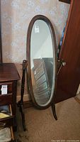 Front view of oval mirror showing full frame and base