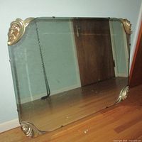 Full view of vintage rectangular wall mirror showing the entire mirror and the four gold gilt corner pieces