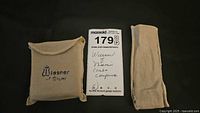 Closed and soft felt pouch labeled Wiesner of Miami for storage of comb and compact