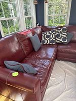 Front-left overview of sectional showing shape, color and pillows