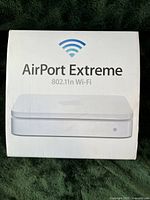 Apple AirPort Extreme product box showing the 802.11n Wi-Fi router image and branding.