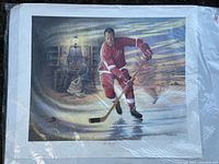 Print titled 'Gordie Howe' showing hockey player on ice, signed and dated 1991 by James Lumbers.