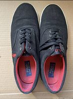 Top view of the Ralph Lauren Polo Forestmont men's shoes showing black fabric uppers, black laces, and red interior lining with Polo Ralph Lauren label on the insole.