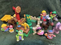 Photo showing a variety of Fisher Price Little People vintage toys including figures, animals, and farm accessories.