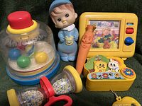 Vintage children's toys collection showing six colorful plastic toys from the 80s/90s