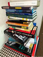 Stack of mixed soft and hard covered books showing titles including Aristophanes Birds and Other Plays, Armageddon Averted, Comedy the Mastery of Discourse, A Great Love, Northern Ireland Since 1968, The Soviet Experiment, and more.