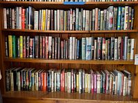 Three shelves of assorted fiction hardcovers and paperbacks