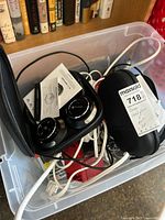 Paww Wavesound 3 headphones and Bose headphones in cases inside a plastic bin