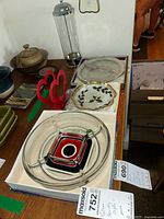 Photo showing assorted serving ware including the Walther crystal divided dish with colorful center, holly and ivy bowl, napkin holder, and other items on table.