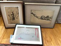 Three prints shown including Michelangelo drawing, a figure drawing, and a Max Beerbohm colorful print