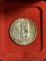 Obverse side of the 1958 Canadian Silver Dollar showing the totem pole design and inscriptions.