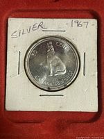 Reverse side of the 1967 Canadian 50-cent coin showing a howling wolf.