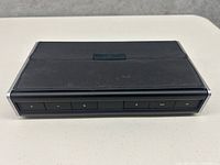 Front view of Bose SoundLink Bluetooth speaker showing control buttons for volume, playback, Bluetooth, and power.