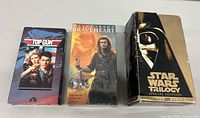 Three VHS tapes: sealed Braveheart, Top Gun, and Star Wars Trilogy Special Edition box set showing front covers.