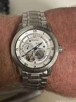 Watch worn on wrist showing fit and wear on bracelet and case