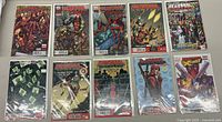 Photo of 11 Deadpool and X-Force comic books laid flat on a surface, showing covers with artwork and titles.