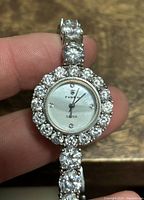 Close-up of the watch face showing clear crystals surrounding the dial with silver-tone accents and the Padmo brand name on the dial.