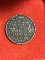 Obverse side shows crowned inscription 'HALF STIVER' within a wreath and the year 1813 with surrounding text indicating Essequibo and Demerary colony usage.