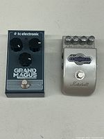 Photo of both pedals showing the TC Electronic Grand Magus and Marshall EH-1 Echohead Delay side by side on a flat surface