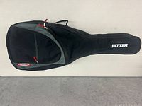 Full view of Ritter soft guitar case in black fabric with front zipper pocket and handle