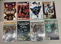 Eight Spider-Man and Batman themed comics laid out showing variety of covers including Deadpool's Secret Wars, Ultimate Spider-Man, and Detective Comics.