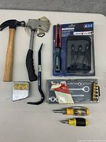 Photo showing two hammers, a pry bar, Mastercraft ratchet screwdriver set, socket wrench set, and two multi-bit screwdrivers
