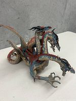 Front side angle of the McFarlane Toys Dragon Hydra figure showing three heads, intricate scale details, and claws.