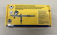 Box showing Vaper Dual Action Gravity Feed Airbrush model 19551 with specifications and features in multiple languages.